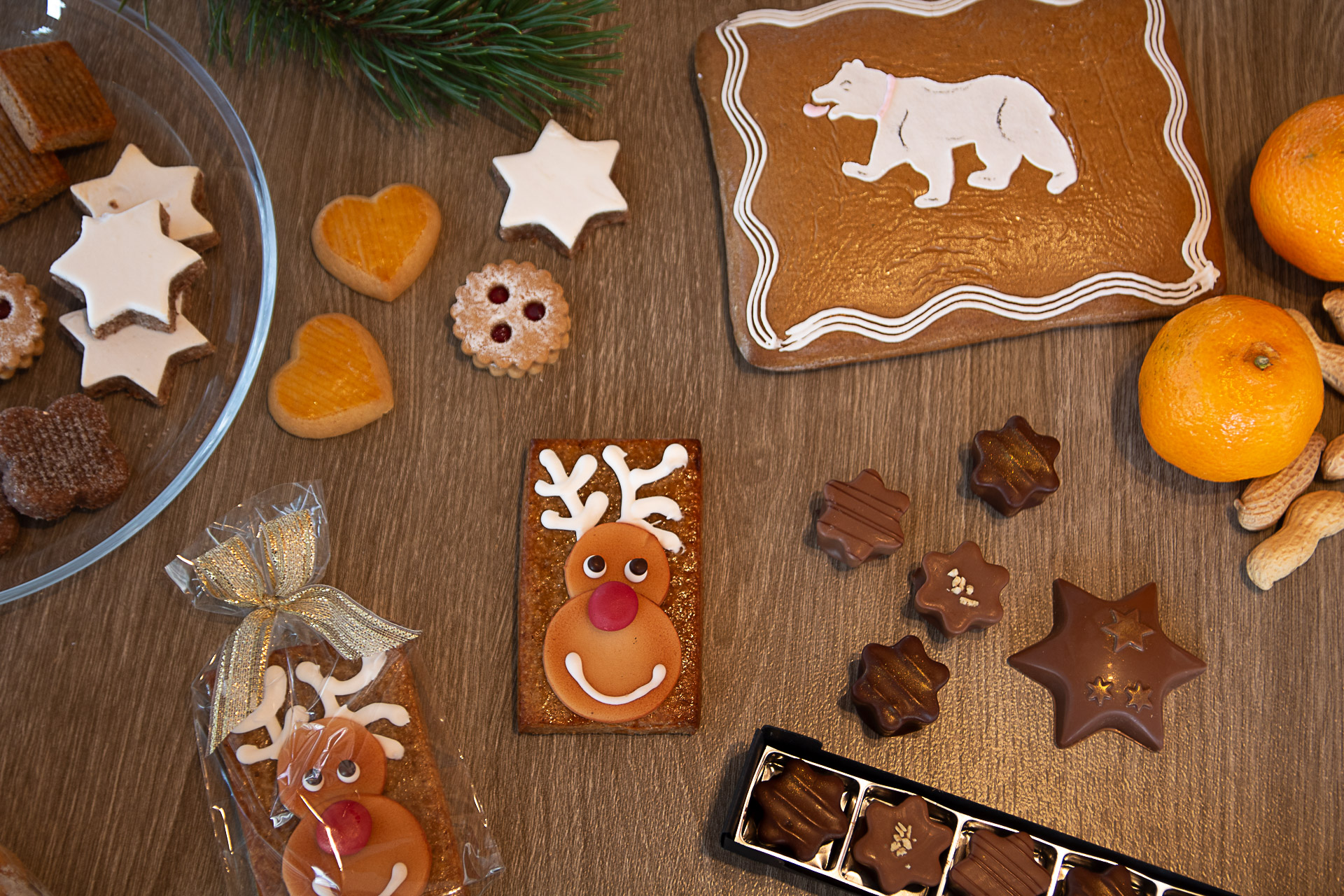 Slider_Weihnachten_tablet Weihnachtskonfekt und Lebkuchen liegen auf einem festlichen Tisch verteilt.